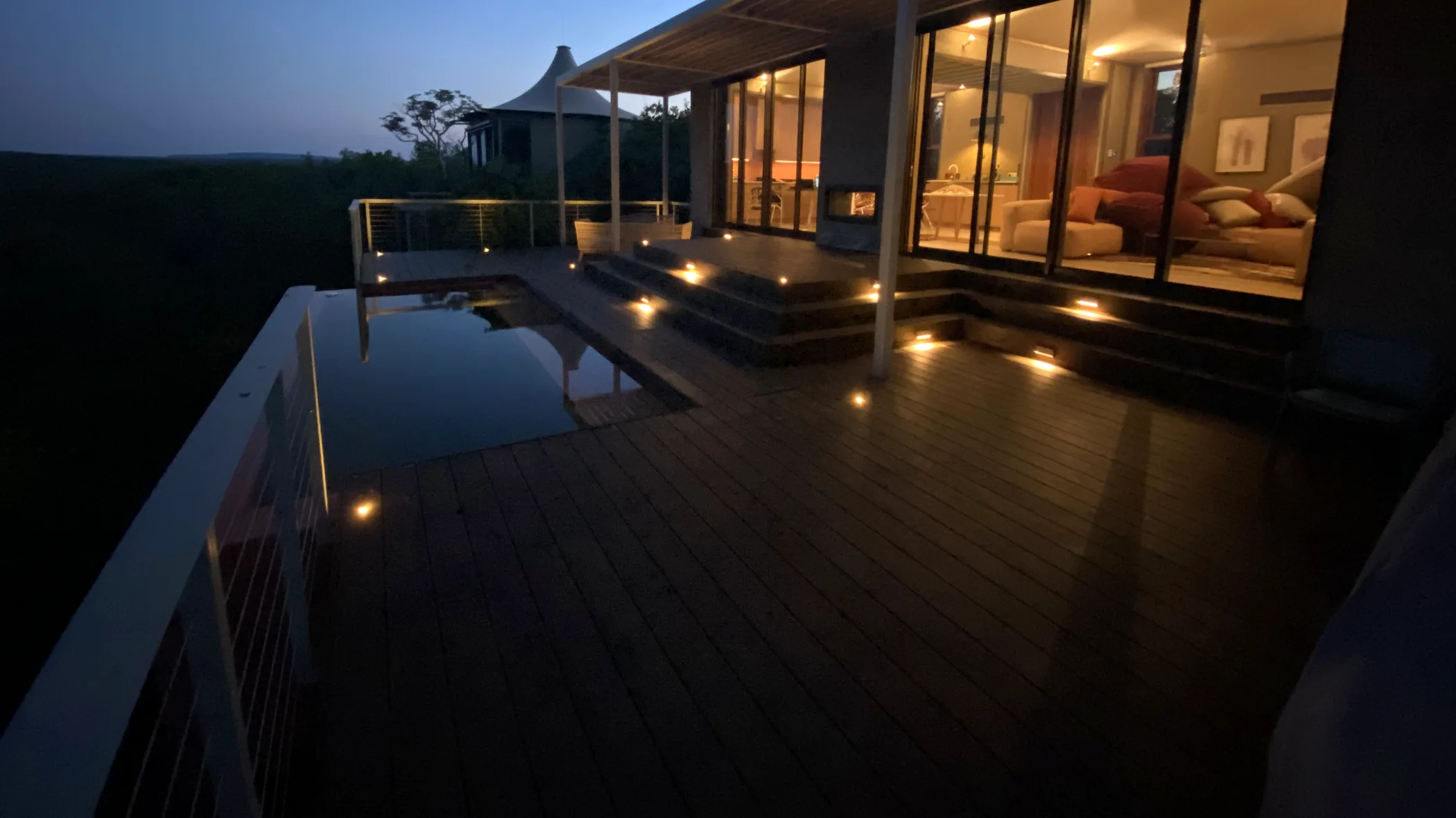 Noka Camp villa deck and plunge pool at dusk with automated step and deck lighting